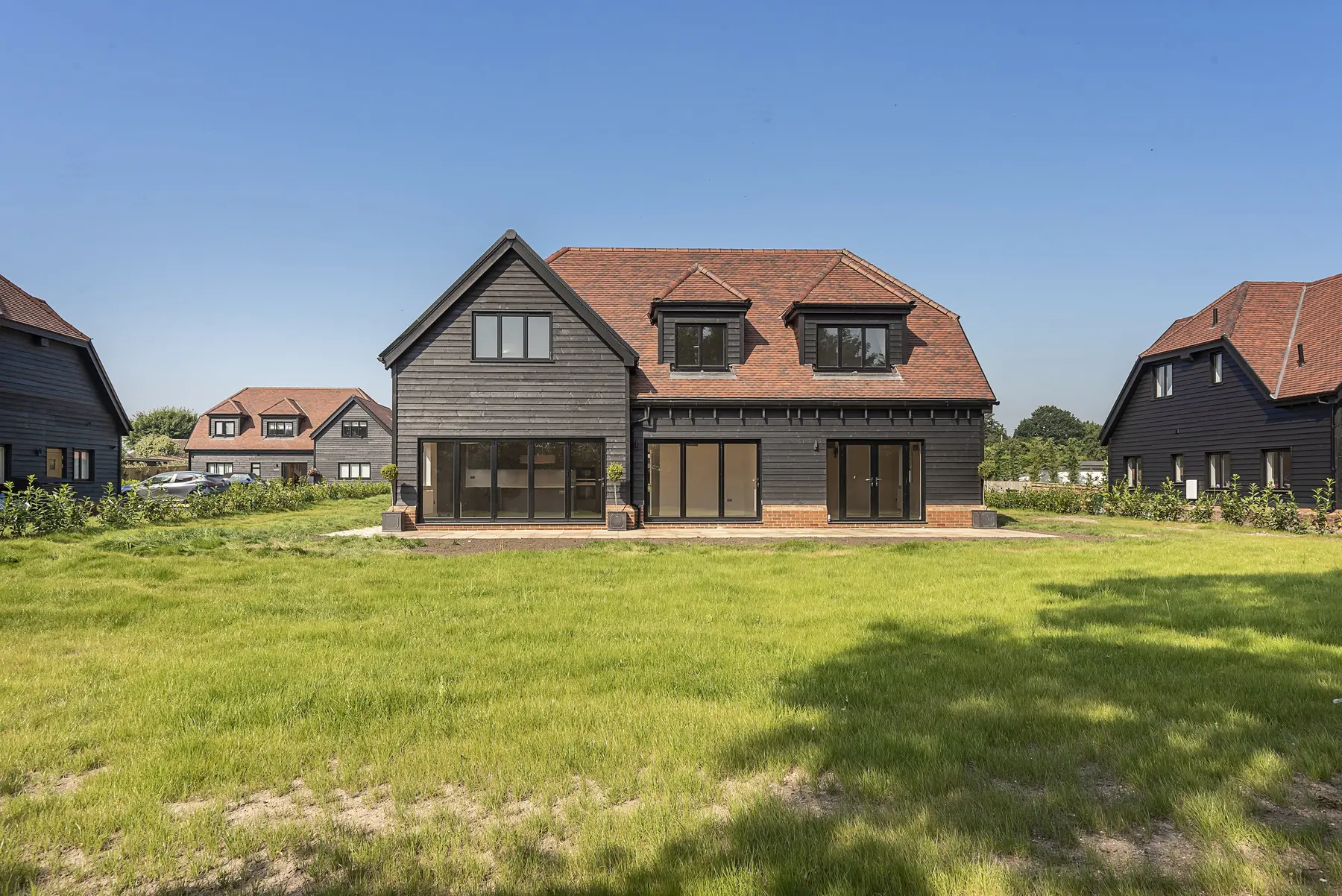 Rear elevation with shiplap cladding and garden - new build Chalfont St Giles HP8