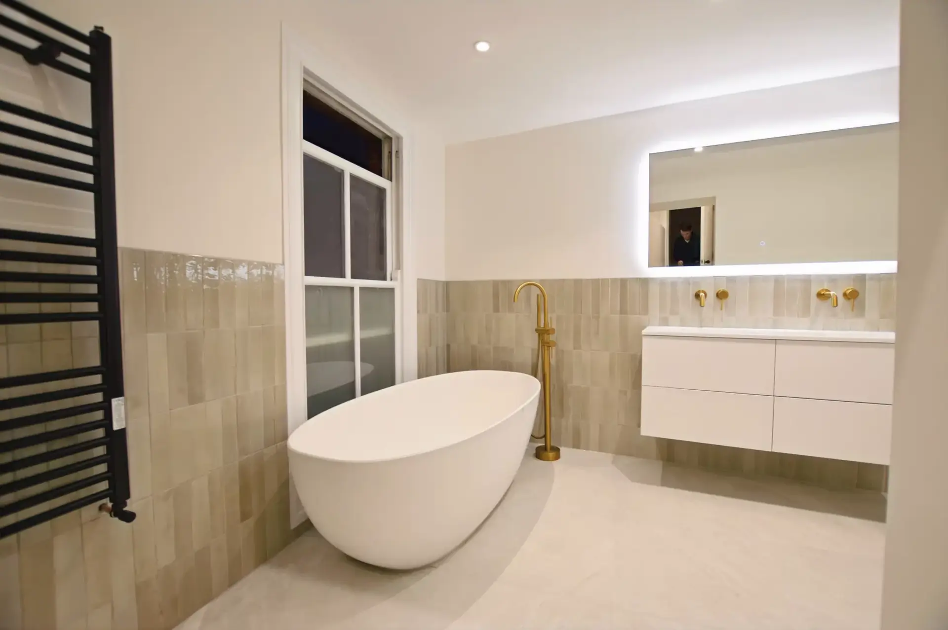 Freestanding bath with brushed brass floor-standing filler, family bathroom