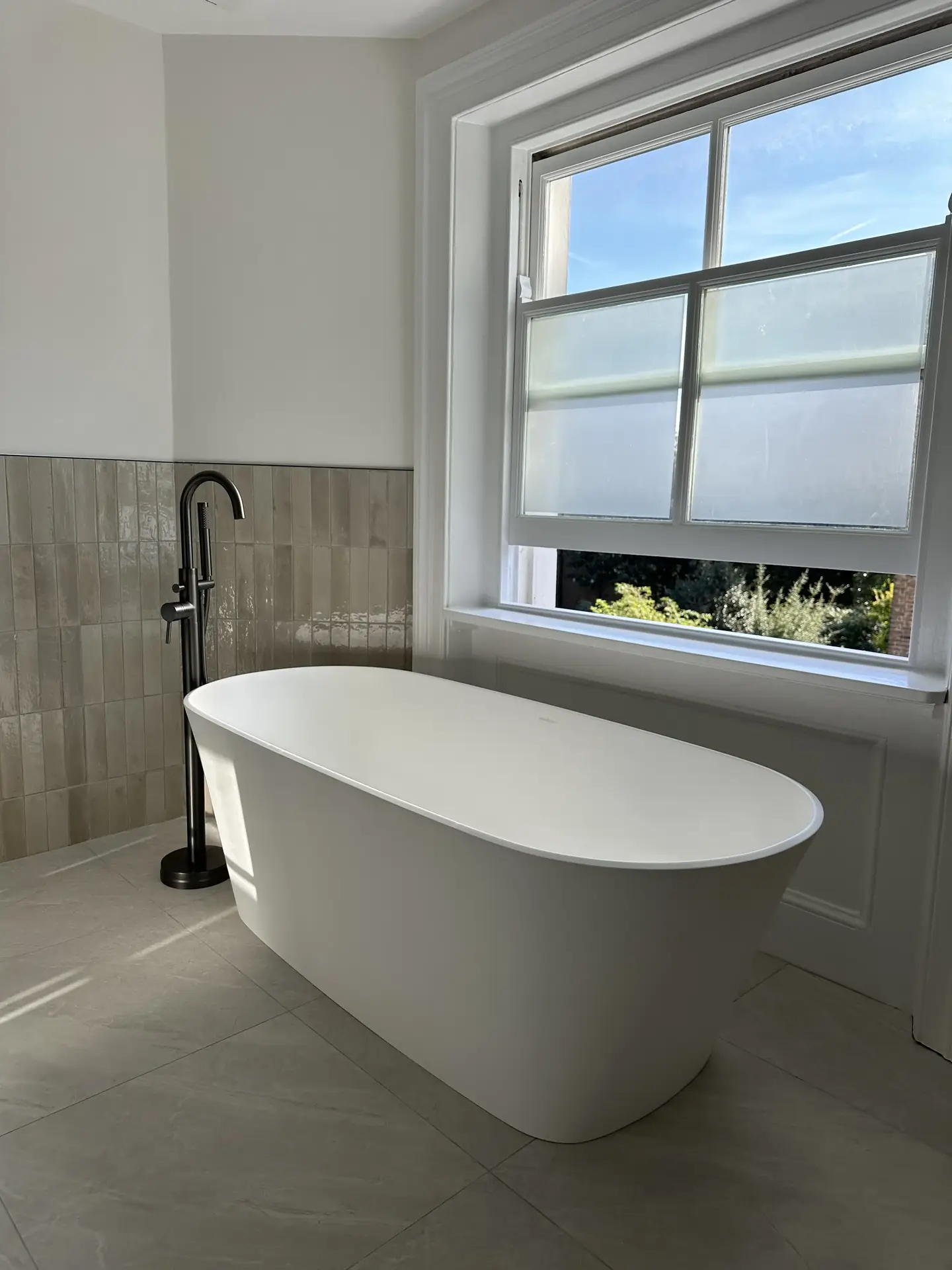Freestanding bath with black floor tap, Clapham bathroom refurbishment
