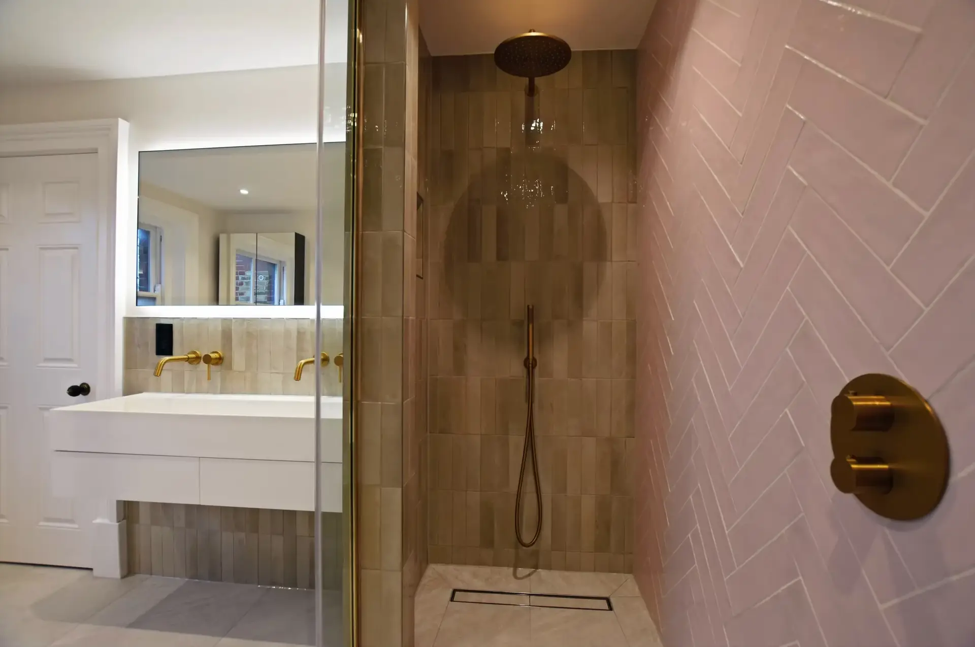 Walk-in shower with brass fixtures and blush tiles, daughter's ensuite