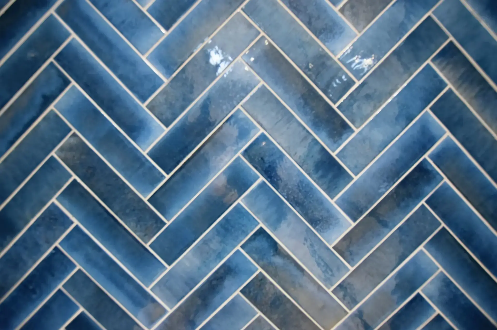 Close-up of navy herringbone glazed tiles, son's ensuite