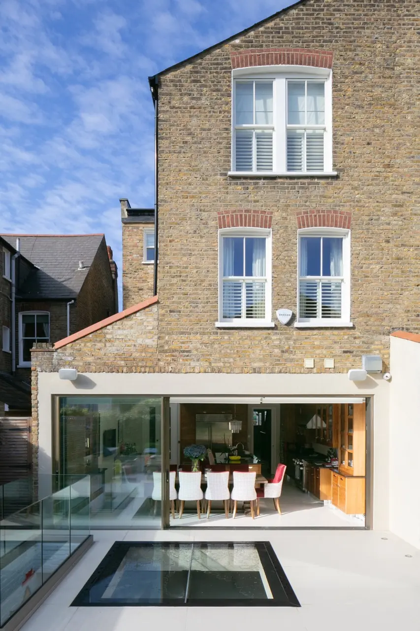 London terraced house rear extension with sliding glass doors, roof light and brick