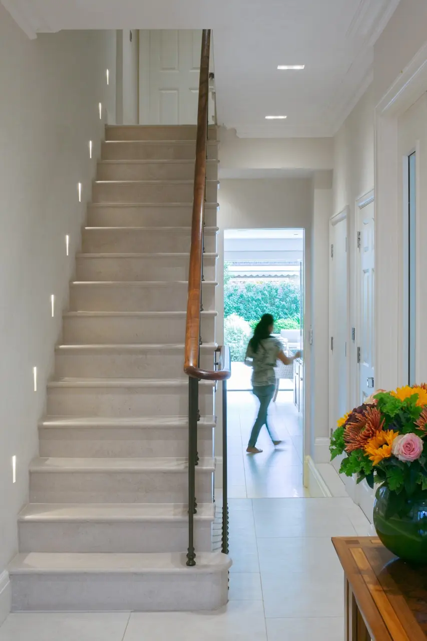 Luxury hallway with marble staircase, LED tread lighting and wood handrail, London