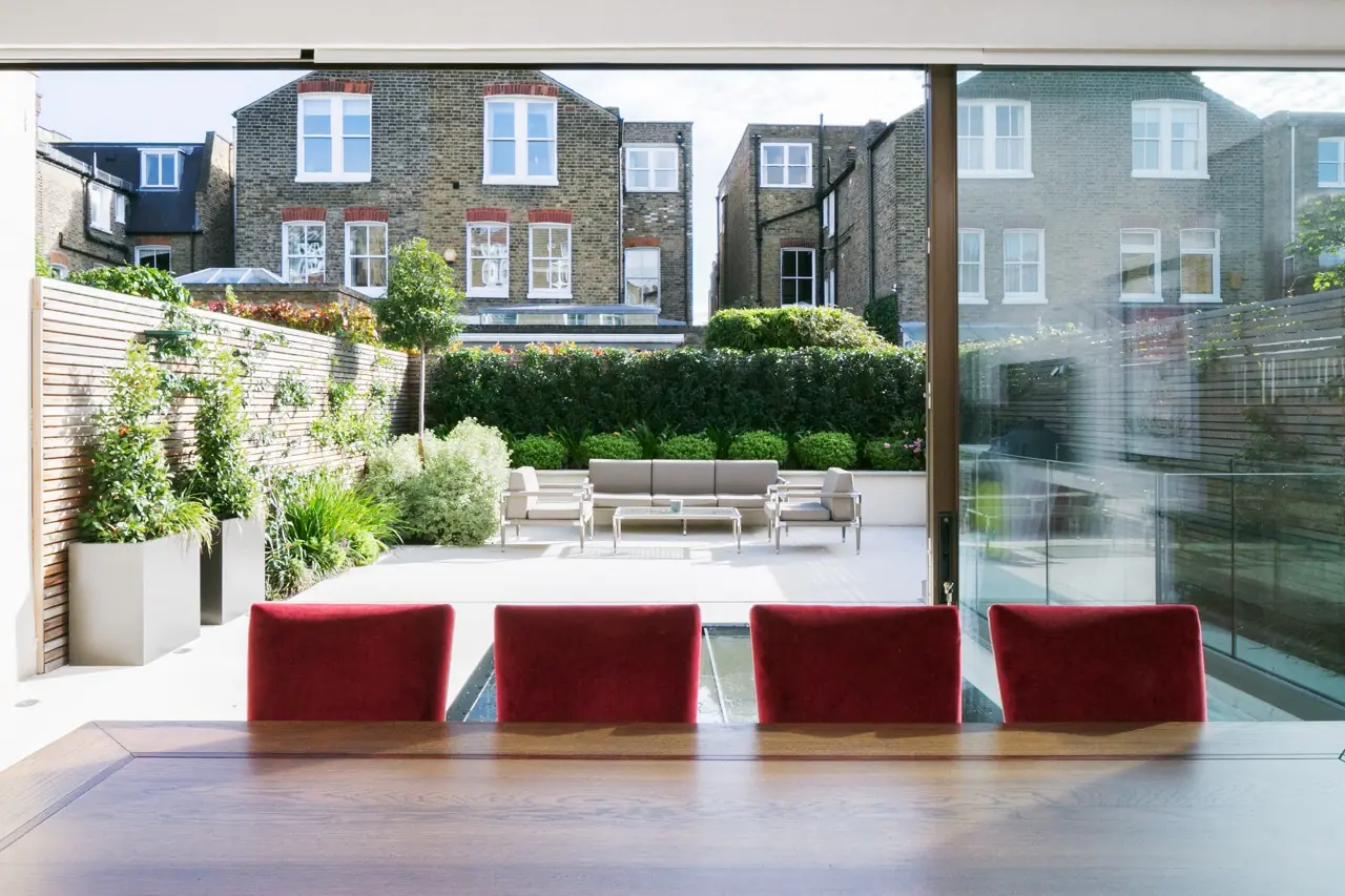 Open plan dining room with sliding glass doors and garden view, London extension