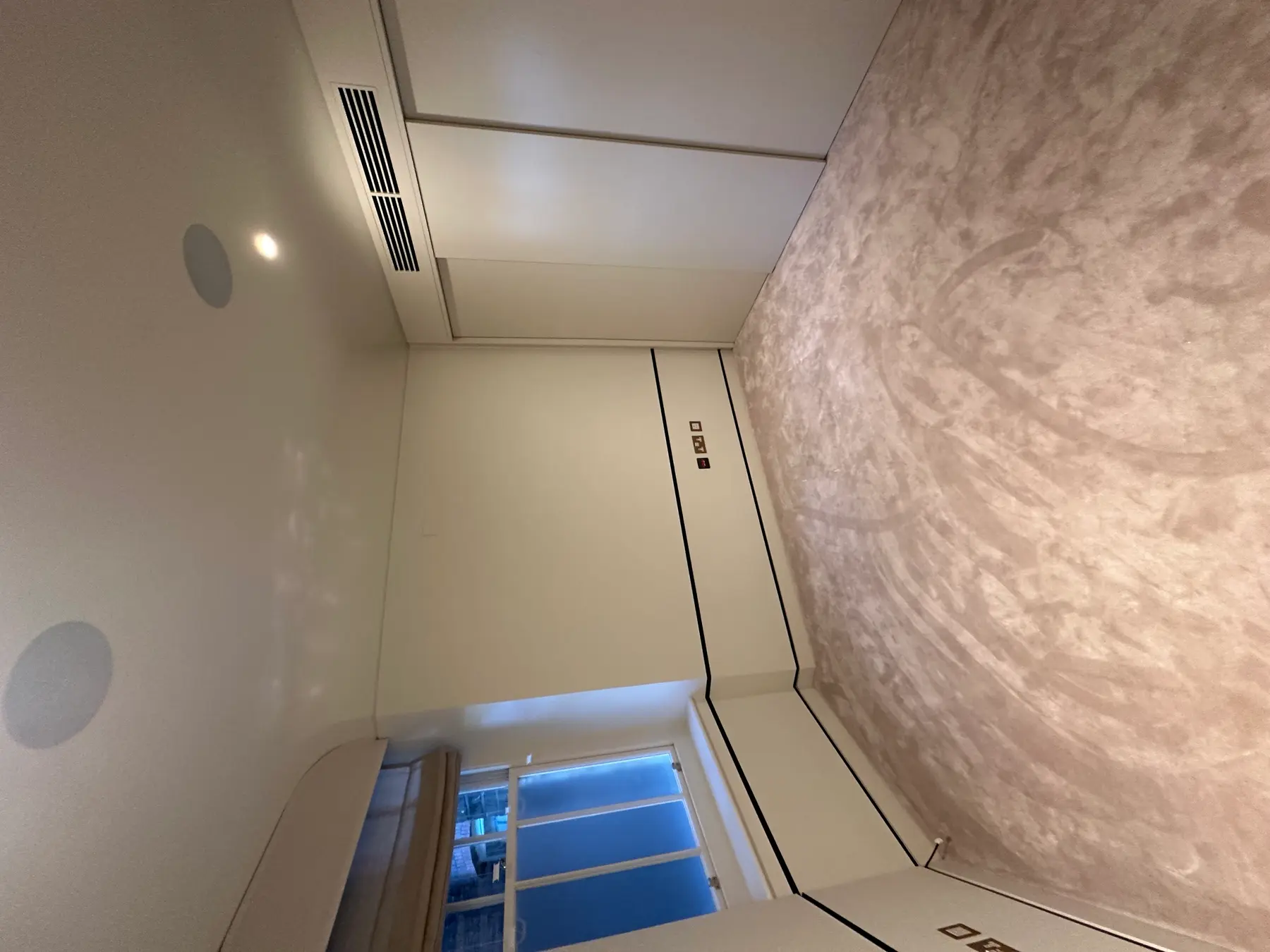 Bedroom with Venetian plaster feature wall, black trim and LED ceiling - Holland Park London