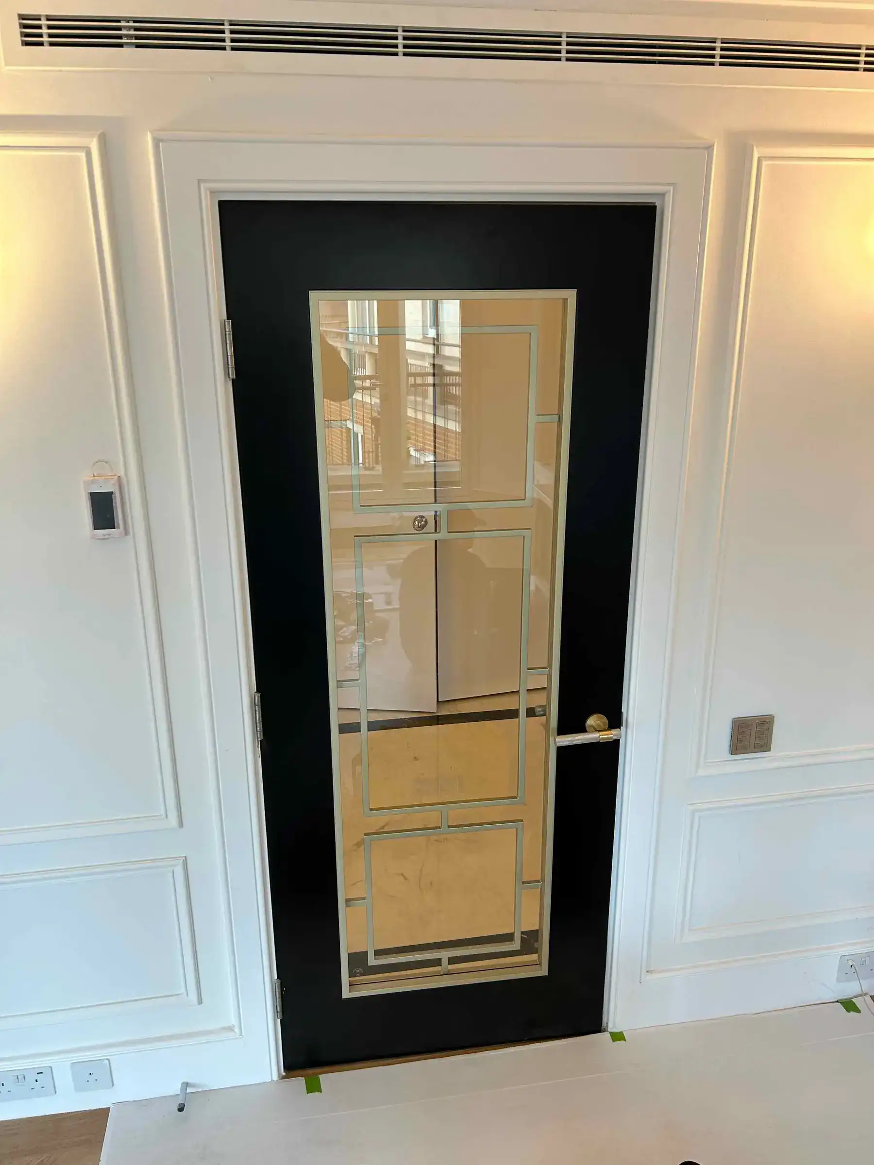 Bespoke Crittall internal door with wall panelling - London apartment Kings Road Chelsea