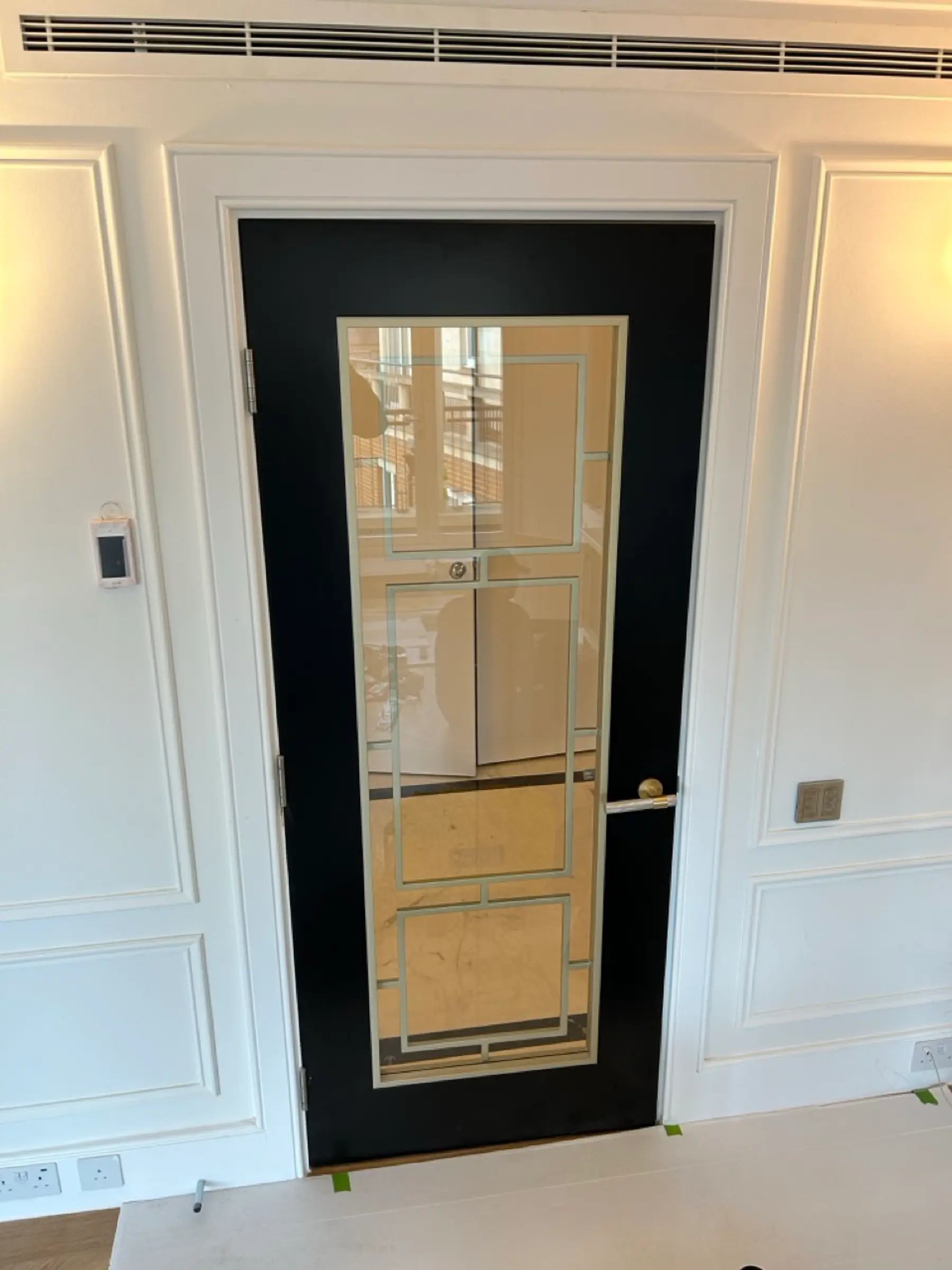 Bathroom with marble tiling and gold sliding shower door - Chelsea apartment refurbishment