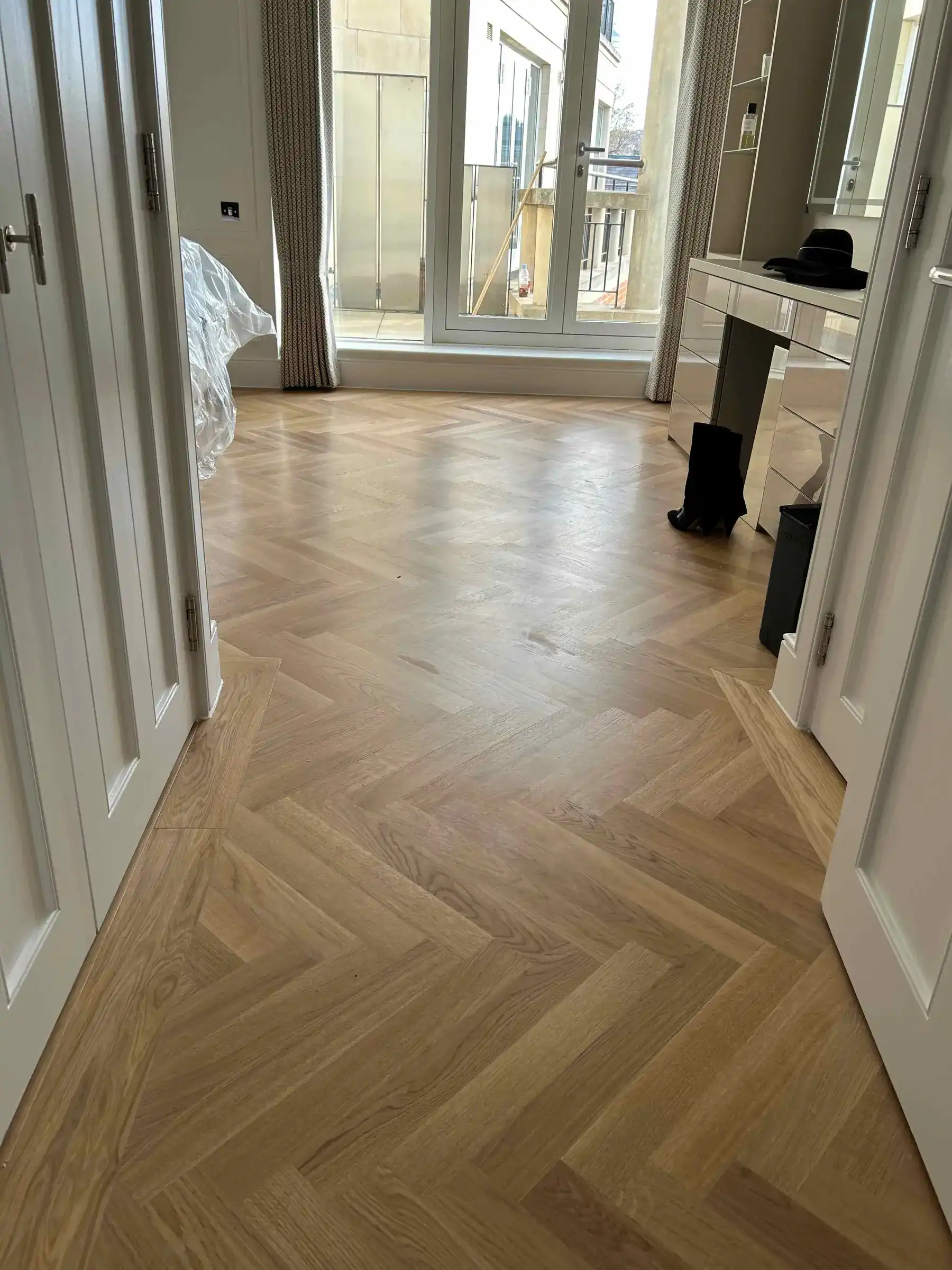 Herringbone oak flooring in bedroom - Kings Road Chelsea apartment refurbishment